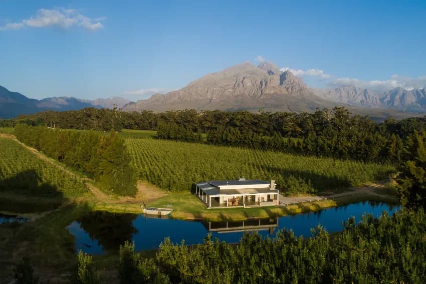 Hot tub on dam edge at Orchard Stay with mountain views
